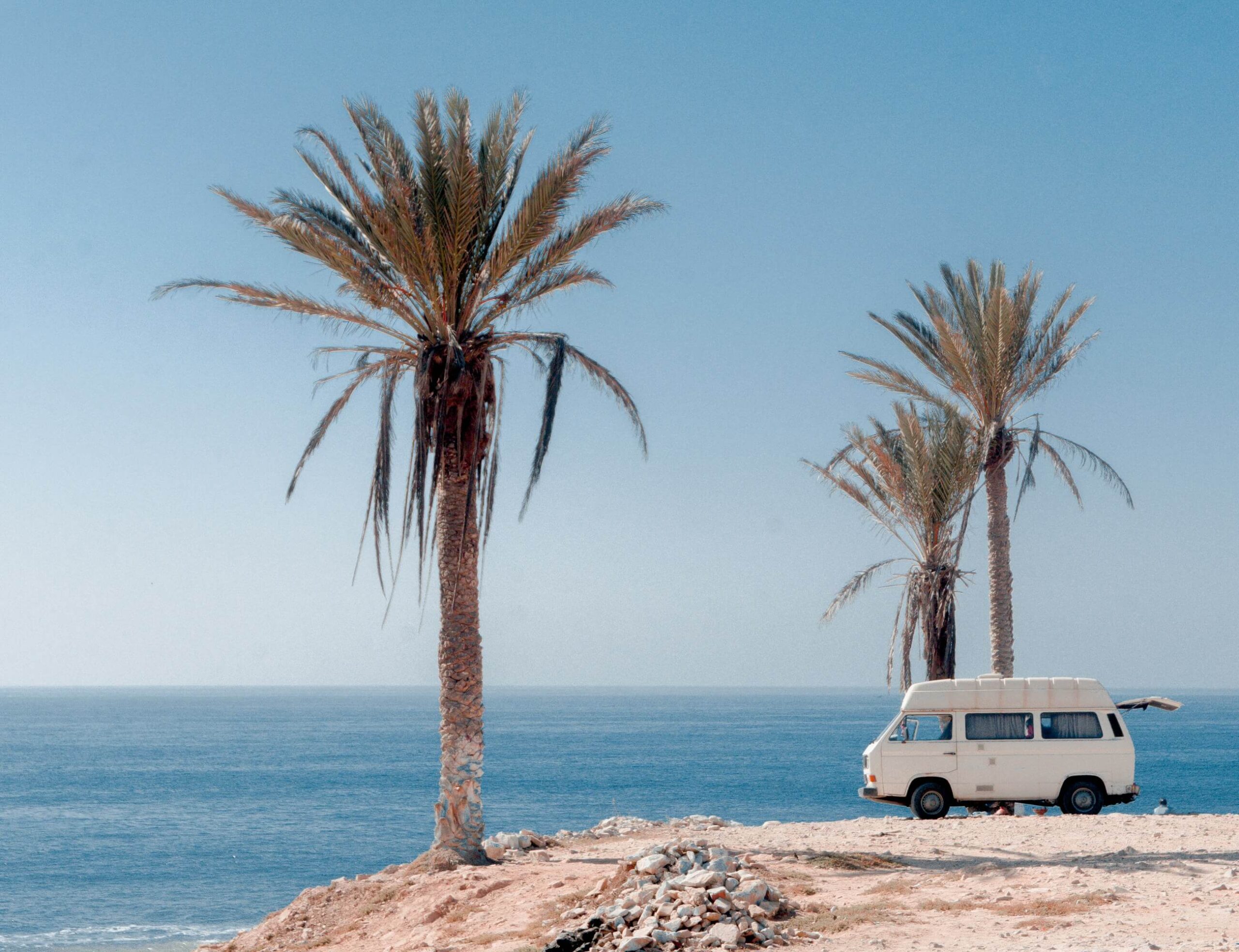 palms and a camping van at Anchor Point, Taghazout