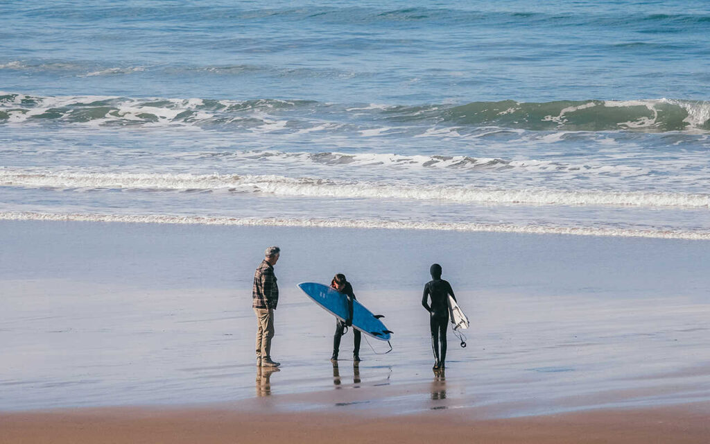 boys surfers with surfboards on the beach during taghazout surfing lesson