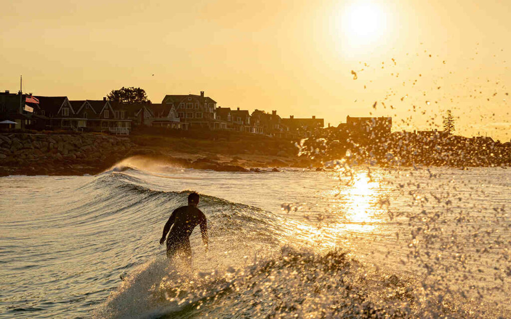 surfer riding waves at the sunset in agadir morocco