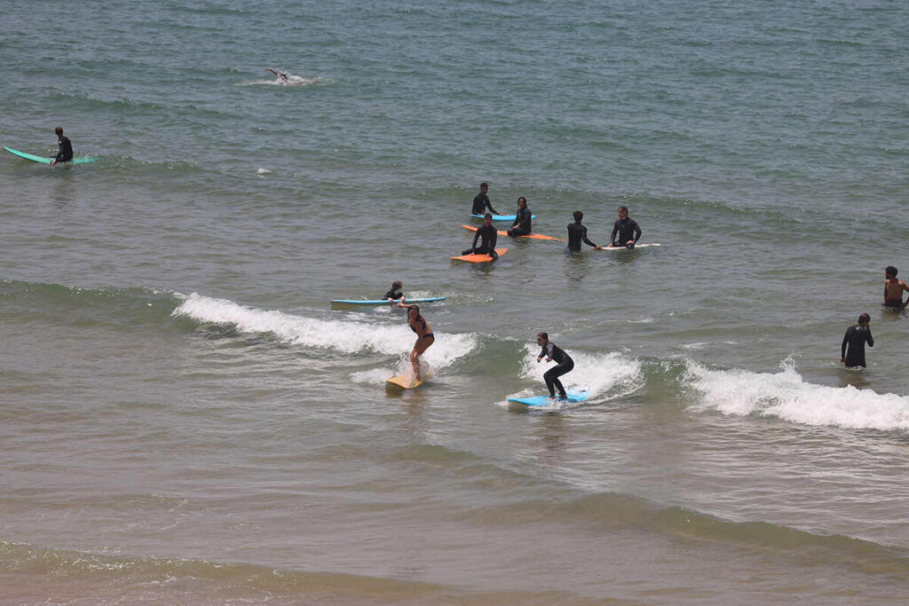 Beginner Surfers Surfing Whitewash In Taghazout